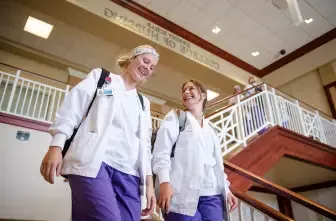 nursing students walking down stairs at the 护理学院